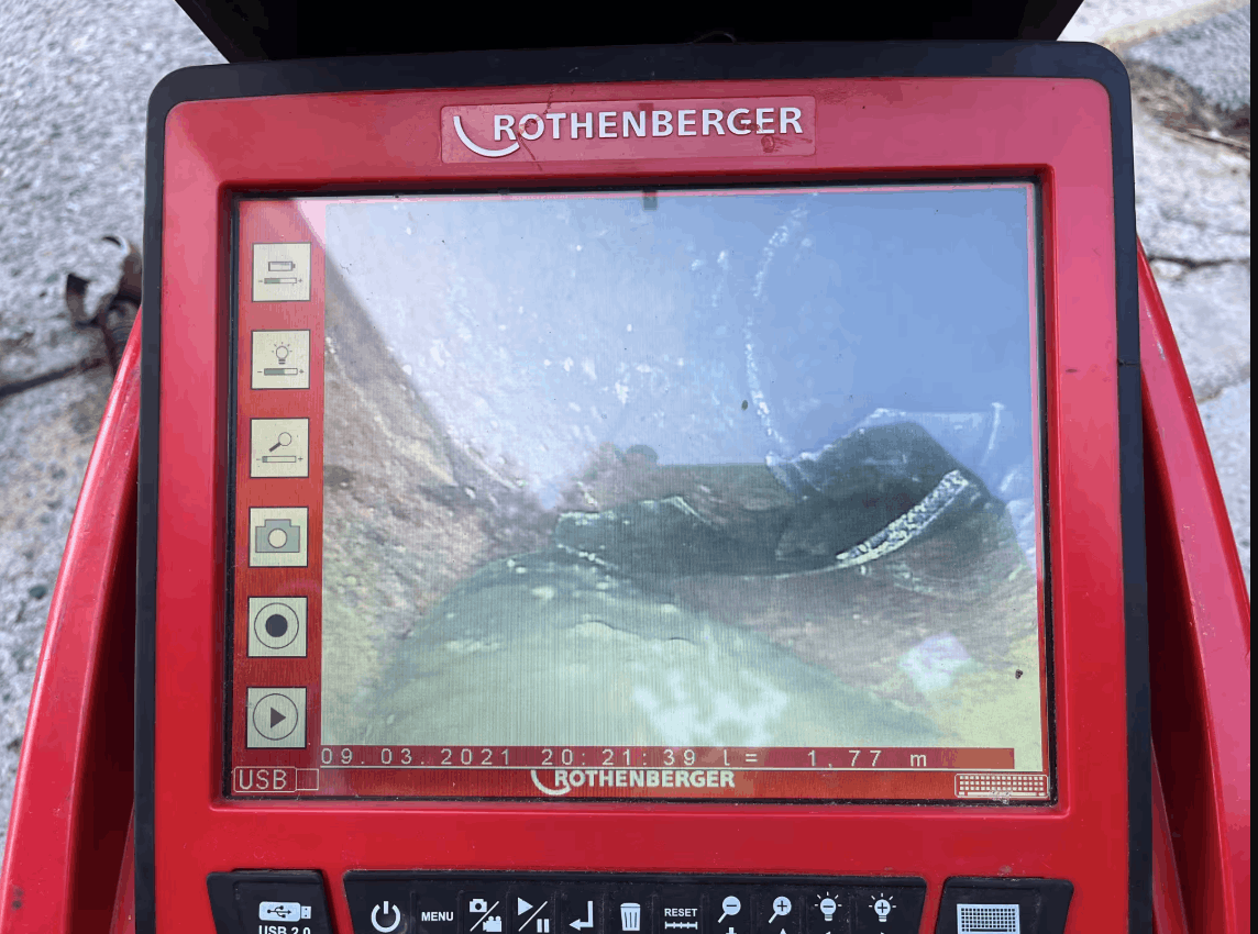CCTV drain inspection showing tree root intrusion inside an underground pipe