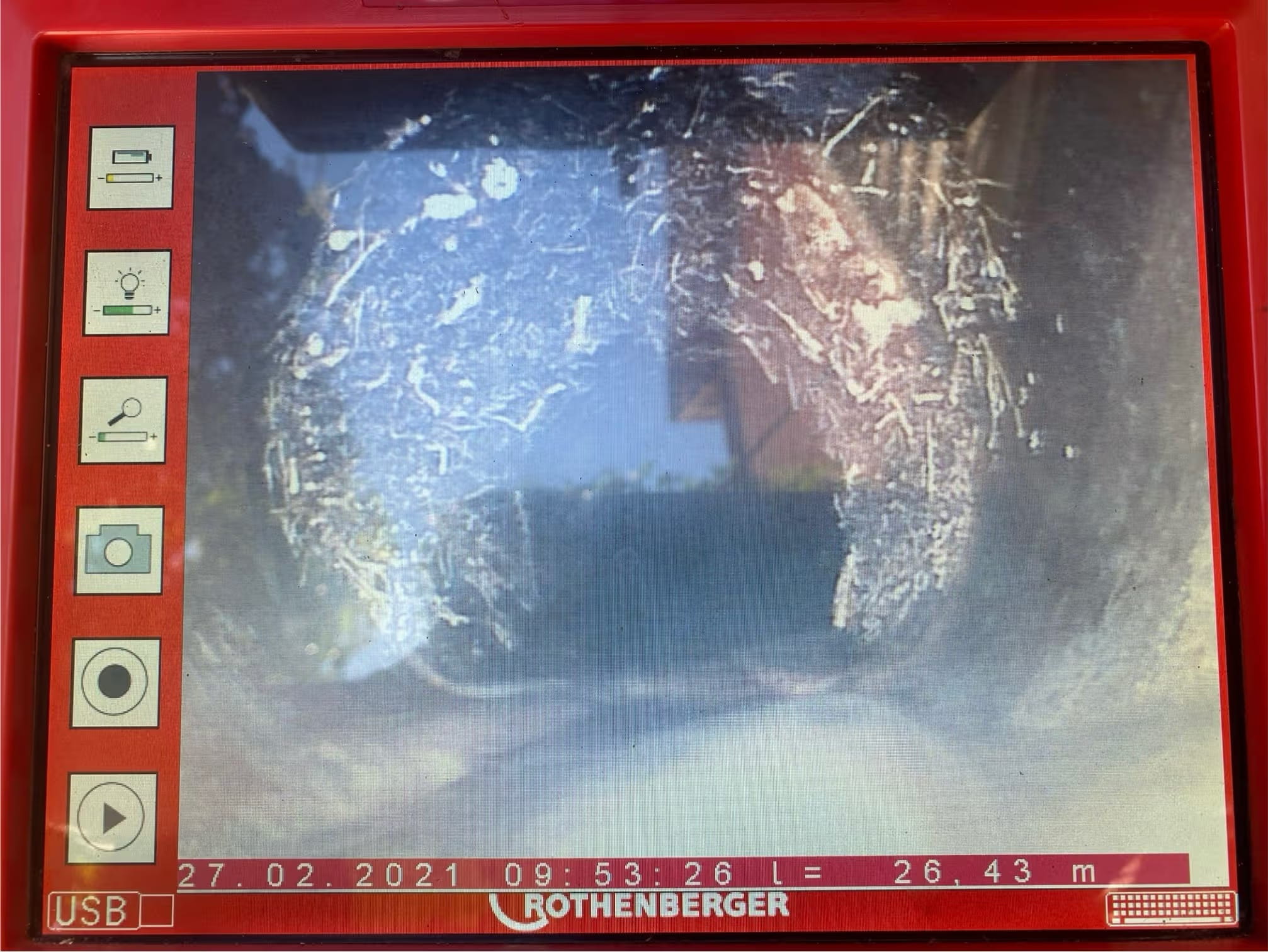 CCTV drain inspection showing tree root intrusion inside an underground pipe