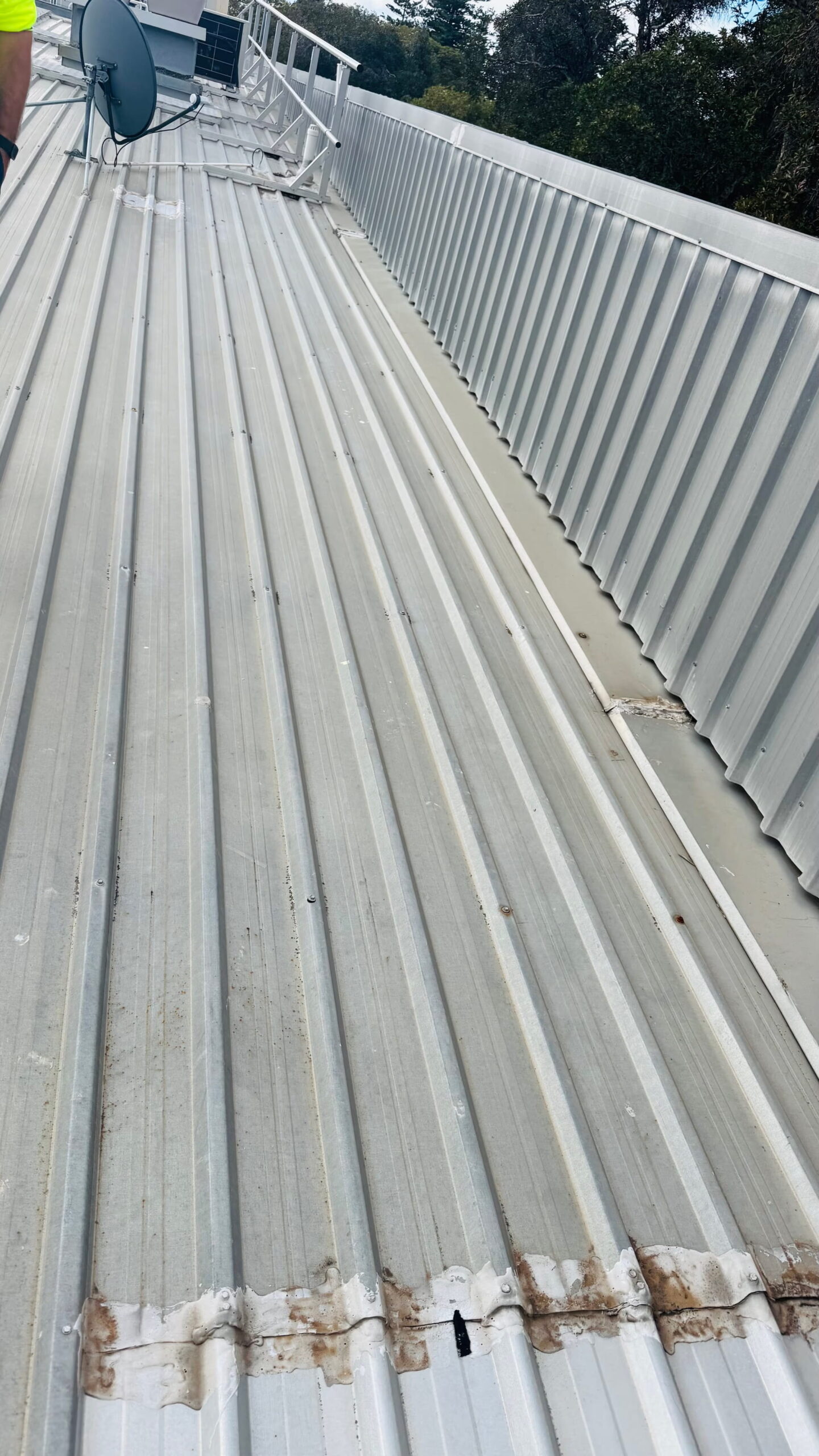 Commercial metal roof showing previous repair work along sheet joins